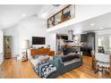 Bright, open-concept living area with hardwood floors, a soaring ceiling, and a modern kitchen at 1952 Don Juan Ln, Decatur, GA 30032