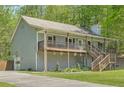 Exterior view of home with a long driveway, basketball net and a charming front porch with wooden rails at 1206 Parkwood Chase, Acworth, GA 30102