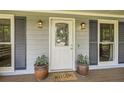 Inviting front entryway with decorative door, potted plants and stylish outdoor lighting creates a welcoming atmosphere at 1206 Parkwood Chase, Acworth, GA 30102