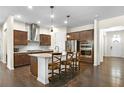 Modern kitchen features dark cabinets, stainless steel appliances, granite countertops, and a breakfast bar at 1318 Crestwind Nw Rd, Kennesaw, GA 30152