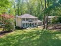 Charming two-story home with a landscaped yard and a classic white facade, surrounded by mature trees at 4505 Glengary Ne Dr, Atlanta, GA 30342