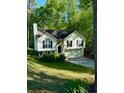 Two-story home with well-maintained lawn and trees at 2180 Ridge Rd, Canton, GA 30114