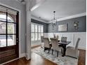 Elegant dining room features hardwood floors, wainscoting, and stylish light fixture at 3330 Camellia Ln, Suwanee, GA 30024
