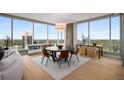 Dining room with modern furnishings, sleek wood floors, and city views at 3630 Peachtree Ne Rd # 3207, Atlanta, GA 30326