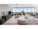 Modern living room with chic furniture and a wall of windows offering city views at 3630 Peachtree Ne Rd # 3207, Atlanta, GA 30326