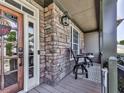 Cozy front porch featuring stone accents and a charming wooden door at 716 Crimson Morning Vw, Canton, GA 30114