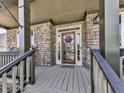 Inviting front porch with stone accents and a decorative wooden door at 716 Crimson Morning Vw, Canton, GA 30114