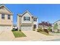 Charming home featuring a two-car garage, manicured lawn, and blue sky at 815 Regal Sw Ln, Atlanta, GA 30331