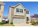 Charming home featuring a two-car garage, manicured lawn, and blue sky at 815 Regal Sw Ln, Atlanta, GA 30331