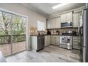 Well-equipped kitchen featuring stainless steel appliances, granite countertops, and access to the deck at 1137 Liberty Nw Pkwy, Atlanta, GA 30318