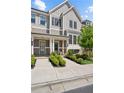 Charming townhome facade with symmetrical landscaping leading to inviting, covered front doors and walkway at 2004 Cortland Rd, Milton, GA 30009