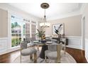 Elegant dining room featuring a modern chandelier, large windows, and stylish decor at 226 Crescent Moon Way, Canton, GA 30114