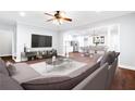 Comfortable living room featuring an open layout, modern furniture, and hardwood flooring at 226 Crescent Moon Way, Canton, GA 30114
