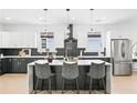 Modern kitchen featuring a waterfall island, stainless steel appliances, and stylish black and white cabinetry at 907 Oakhill Sw Ave, Atlanta, GA 30310