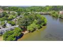 An aerial view showcasing the river running beside the complex, set among lush trees at 1119 Riverbend Club Se Dr, Atlanta, GA 30339