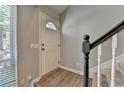 Entryway featuring a staircase, hardwood floors, neutral-colored walls, and a white front door with window insert at 1119 Riverbend Club Se Dr, Atlanta, GA 30339