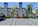 Exterior view of townhome featuring clean parking spaces and well-kept landscaping at 1119 Riverbend Club Se Dr, Atlanta, GA 30339