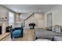 Cozy living room with a decorative fireplace, gray walls, and wood-look floors at 1119 Riverbend Club Se Dr, Atlanta, GA 30339