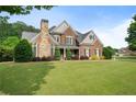 Beautiful two-story home with a large front lawn, manicured landscaping and brick exterior at 416 Battlefield Creek Dr, Marietta, GA 30064