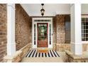 Inviting front entrance with brick facade, decorative wreath, and charming 'HELLO' door mat at 416 Battlefield Creek Dr, Marietta, GA 30064