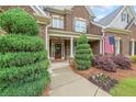 Inviting entrance to home features landscaping, mature trees, and an American flag at 416 Battlefield Creek Dr, Marietta, GA 30064