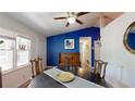 Bright dining room with blue walls, natural light, and unique decor elements at 679 Suwanee Ct, Lawrenceville, GA 30043