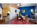 Inviting dining room with blue accent wall, decorative rug, and comfortable seating at 679 Suwanee Ct, Lawrenceville, GA 30043