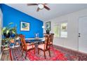 Dining area features a bold blue accent wall, a large window, and charming decor at 679 Suwanee Ct, Lawrenceville, GA 30043