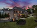 Beautiful home with lush landscaping and a cozy backyard fire pit area for outdoor gatherings at 903 Shaftoe Nw St, Kennesaw, GA 30152
