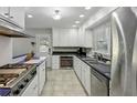 Functional kitchen featuring sleek white cabinets, modern appliances, and a stainless steel sink at 1649 Clairmont Ne Way, Brookhaven, GA 30329