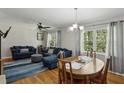 Inviting living room with hardwood floors, a ceiling fan, and a comfortable blue sofa set at 1649 Clairmont Ne Way, Brookhaven, GA 30329