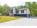 Stylish home with a prominent chimney, gated driveway, and a spacious concrete pad at 2619 Kellogg Creek Rd, Acworth, GA 30102