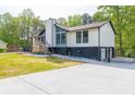 A beautifully renovated home featuring an intricate front patio and a secure gated driveway at 2619 Kellogg Creek Rd, Acworth, GA 30102