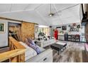 Inviting living area with vaulted ceilings, barn door, modern furnishings, and wood plank flooring at 2619 Kellogg Creek Rd, Acworth, GA 30102