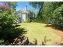 Spacious backyard with lush green lawn, surrounded by mature trees and greenery, creating a private oasis at 2990 Byrons Green Ct, Marietta, GA 30062