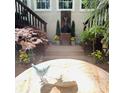 Charming courtyard with a stone fountain, lush greenery, and a decorative bird bath at 2990 Byrons Green Ct, Marietta, GA 30062