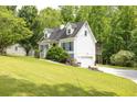 Charming two-story home with a convenient driveway and a lush green lawn at 2009 Shipwreck Ct, Buford, GA 30518