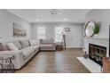 Bright living room with a marble fireplace, and a comfortable sectional sofa at 4128 Boxwood Way, Duluth, GA 30096