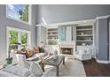 Comfortable living room featuring built-in bookshelves, a fireplace, and neutral décor at 900 Crossfire Nw Rdg, Marietta, GA 30064