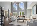 Bright living room boasts soaring ceilings, large windows, fireplace, and hardwood floors at 900 Crossfire Nw Rdg, Marietta, GA 30064