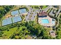 An aerial view of community amenities featuring tennis courts, pool, playground and clubhouse at 2315 Saddle Brook Trce, Cumming, GA 30040