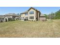Spacious backyard featuring a patio and well-maintained lawn at 2315 Saddle Brook Trce, Cumming, GA 30040