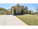Charming two-story brick home featuring a driveway and well-maintained lawn at 2315 Saddle Brook Trce, Cumming, GA 30040