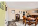An open dining room area with hard surface floors, vintage furniture, and a charming, neutral color palette at 2376 Falls River Dr, Lithia Springs, GA 30122