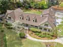 Aerial view of a single-Gathering home featuring lush landscaping, a putting green, and a driveway at 299 Saint Marys Nw Ln, Marietta, GA 30064