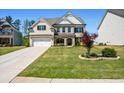 Lovely home featuring a brick facade, a well-manicured lawn, and a two-car garage at 4188 Fawn Ivy Ln, Marietta, GA 30064