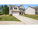 Charming two-story home with a brick front, lush green lawn, and attached two-car garage at 4188 Fawn Ivy Ln, Marietta, GA 30064