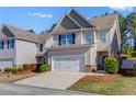 Charming two-story home features a two car garage, neutral siding, and well maintained landscaping at 102 Hill Crest Cir, Hiram, GA 30141
