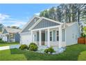 Charming single-Gathering home with a two-car garage, a covered porch, and landscaped front yard at 790 Riverwood Pass, Dallas, GA 30157