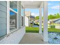 Covered front porch with classic white columns, stone accents, and well-manicured landscaping at 790 Riverwood Pass, Dallas, GA 30157